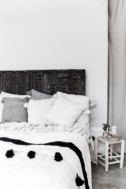 esencia nómada. pompon blanket, taburete de madera y handira marroquí